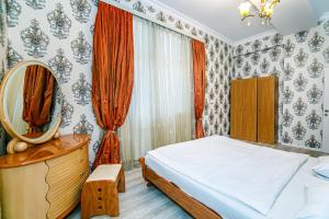 a bedroom with a bed and a mirror at Deluxe Apartment 128/34 in Baku