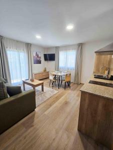 a living room with a kitchen and a dining room at A Quinta de Cea - Apartamentos in Cea