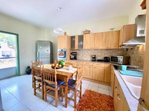 a kitchen with a wooden table with chairs and a tableasteryasteryasteryasteryastery at Captain's House in Kalymnos