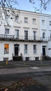 a white building with a balcony on top of it at Studio apartment - The Sapphire 