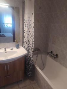 a bathroom with a sink and a shower curtain at Amplio apartamento Blanes in Blanes +13 photos