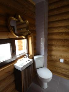 a bathroom with a toilet and a sink at Къща за Гости in Ivanyane