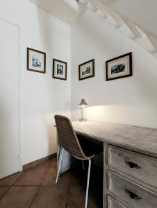 a desk with a chair and three pictures on the wall at A CASA ROSSA , La Marjolaine in Saint Paul de Vence