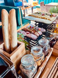 a buffet of food with bread and other foods at Scandi Resort in Zator