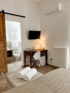 Televízia a/alebo spoločenská miestnosť v ubytovaní San Michele Luxury Rooms