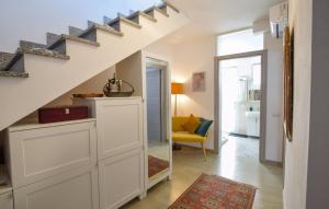 a living room with a staircase and a room with a couch at Casa Gianni in SantʼAntìoco