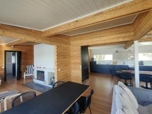 a dining room and kitchen with a table and chairs at Villa Lahnajärvi in Salo