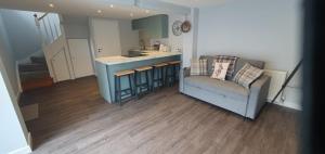 a living room with a couch and a kitchen at The Old Cart Shed in Pollington
