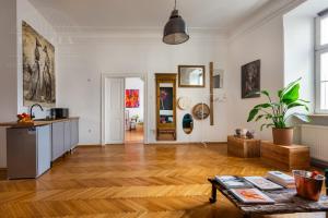 a living room with a wooden floor and white walls at Apartament Rynek Główny 7 in Krakow
