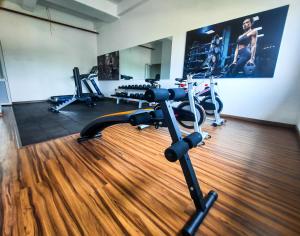 a gym with treadmills and exercise bikes in a room at Sea Wave in Negombo