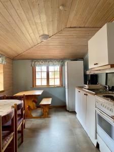 Il comprend une cuisine équipée d'un réfrigérateur blanc et d'une table. dans l'établissement Trollstigen Camping and Gjestegård, à Åndalsnes