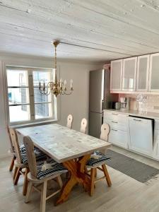 a kitchen with a dining room table and chairs at Old Town B&B Ida-Maria in Porvoo