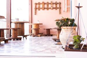 埃爾莫波利斯的住宿－Onar Syros - Rustic Rooms，一间设有桌子和盆栽的房间