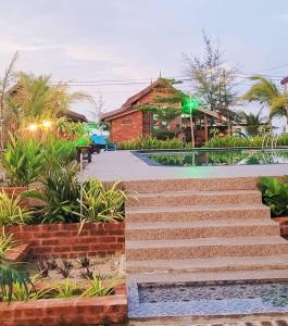 a resort with a swimming pool and some stairs at PULANG RESORT in Setiu