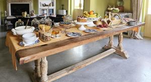 a long wooden table with food on top of it at Relais Casa Mirabile in Menfi
