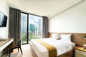Krevet ili kreveti u jedinici u okviru objekta Rasuna Icon Hotel