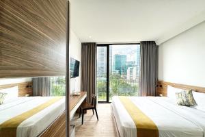 Postel nebo postele na pokoji v ubytování Rasuna Icon Hotel + 27 fotografií