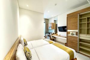 Krevet ili kreveti u jedinici u okviru objekta Rasuna Icon Hotel