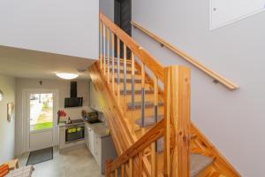 a wooden staircase leading up to a kitchen with a counter at Villa del Sol in Sztutowo