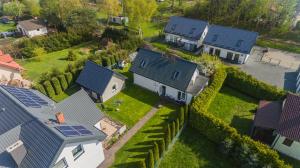 an overhead view of a house with solar panels on its roofs at Villa del Sol in Sztutowo