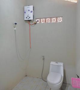 a bathroom with a toilet and a shower at Omah Joglo Sukorejo RedPartner in Sukareja +44 photos