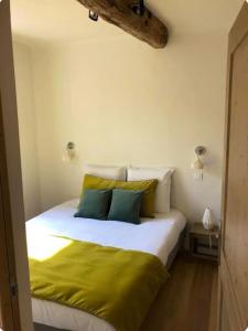 a bedroom with a large white bed with green sheets at Terrazzo in Bastia