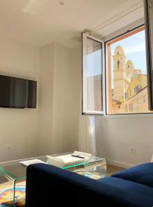 a living room with a glass coffee table and a window at Terrazzo in Bastia