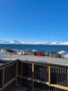 a view of the ocean from the deck of a house at Yggdrasil Sea View Lodge in Tromsø