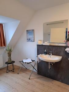 uma casa de banho com um lavatório e um espelho em St. Jobser Hof em Würselen