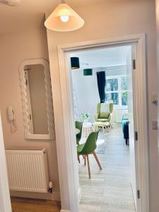 a hallway with a green chair and a mirror at Port of Dover Apartments in Kent