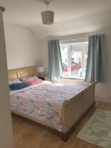a bedroom with a bed and a window at Spacious 3 bed townhouse in Dublin 12 in Dublin