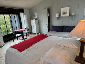 a bedroom with a large bed and a desk at Ma Chambre d'Amis in Saint-Clément-des-Baleines