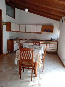 a kitchen with a table and chairs in a room at La Colombara in Fara Vicentino