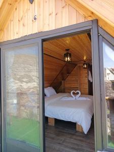 a bedroom with a bed in a log cabin at Dana luxury huts in Dana