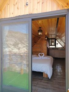 a bedroom with a bed and a large sliding glass door at Dana luxury huts in Dana +114 photos