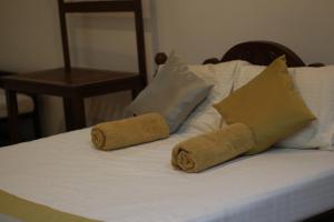a bed with two towels on top of it at Xotic Resort Upper Floor in Kurunegala