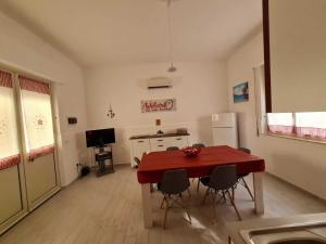 a living room with a red table and chairs at The Dreams House Mondello in Mondello