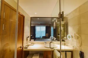 a bathroom with a sink and a mirror at Crowne Plaza Nairobi Airport by IHG in Nairobi