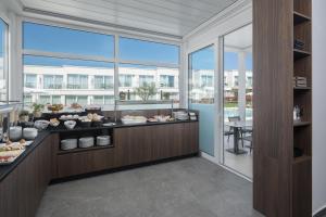 a restaurant with a buffet of food on a counter at Maj Luxury Residence in Poreč
