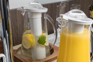 a couple of juicervisors with orange juice and lemon slices at Maj Luxury Residence in Poreč