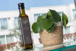 a bottle of wine next to a potted plant at Maj Luxury Residence in Poreč