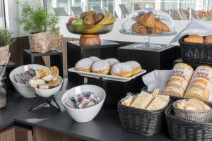 a buffet with bread and pastries on a table at Maj Luxury Residence in Poreč
