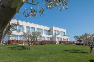 an apartment building with a lawn in front of it at Maj Luxury Residence in Poreč