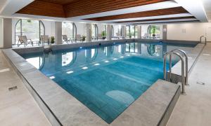 a large swimming pool with blue water at Cliffden Hotel in Teignmouth