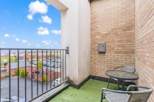 a patio with a table and chairs on a balcony at 247 Serviced Accommodation in Telford 2 BR Apartment in Telford