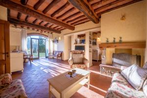 a living room with a couch and a fireplace at Savignola Paolina in Greve in Chianti