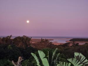 a full moon rising over the ocean at dusk at Ndiza Lodge and Cabanas in St Lucia