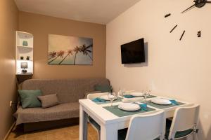 a living room with a white table and a couch at Apartment Wish - two bedrooms with 2 AC renewed in Pag