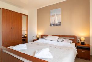 a bedroom with a bed with towels on it at Apartment Wish - two bedrooms with 2 AC renewed in Pag