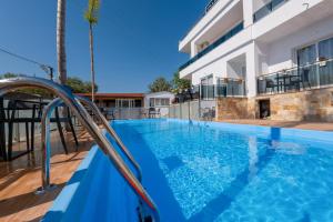 a swimming pool in front of a house at Vila Irdi in Ksamil